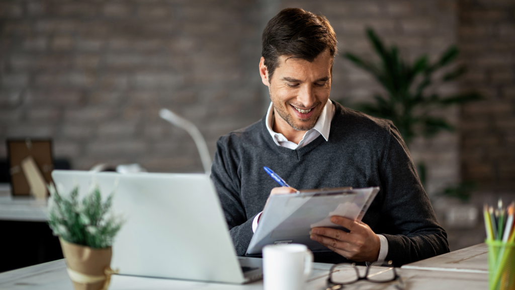 smiling-employee-working-laptop-office